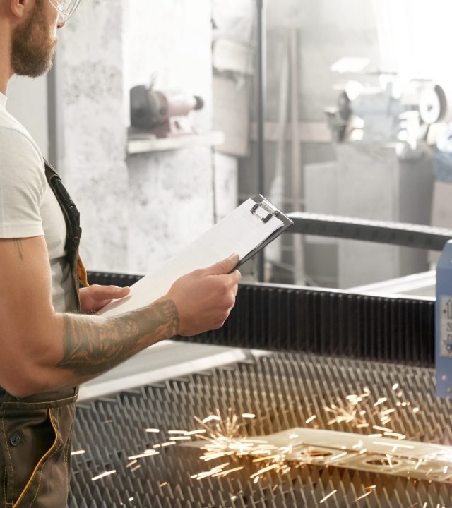 engineer controlling plasma laser cutting metal.